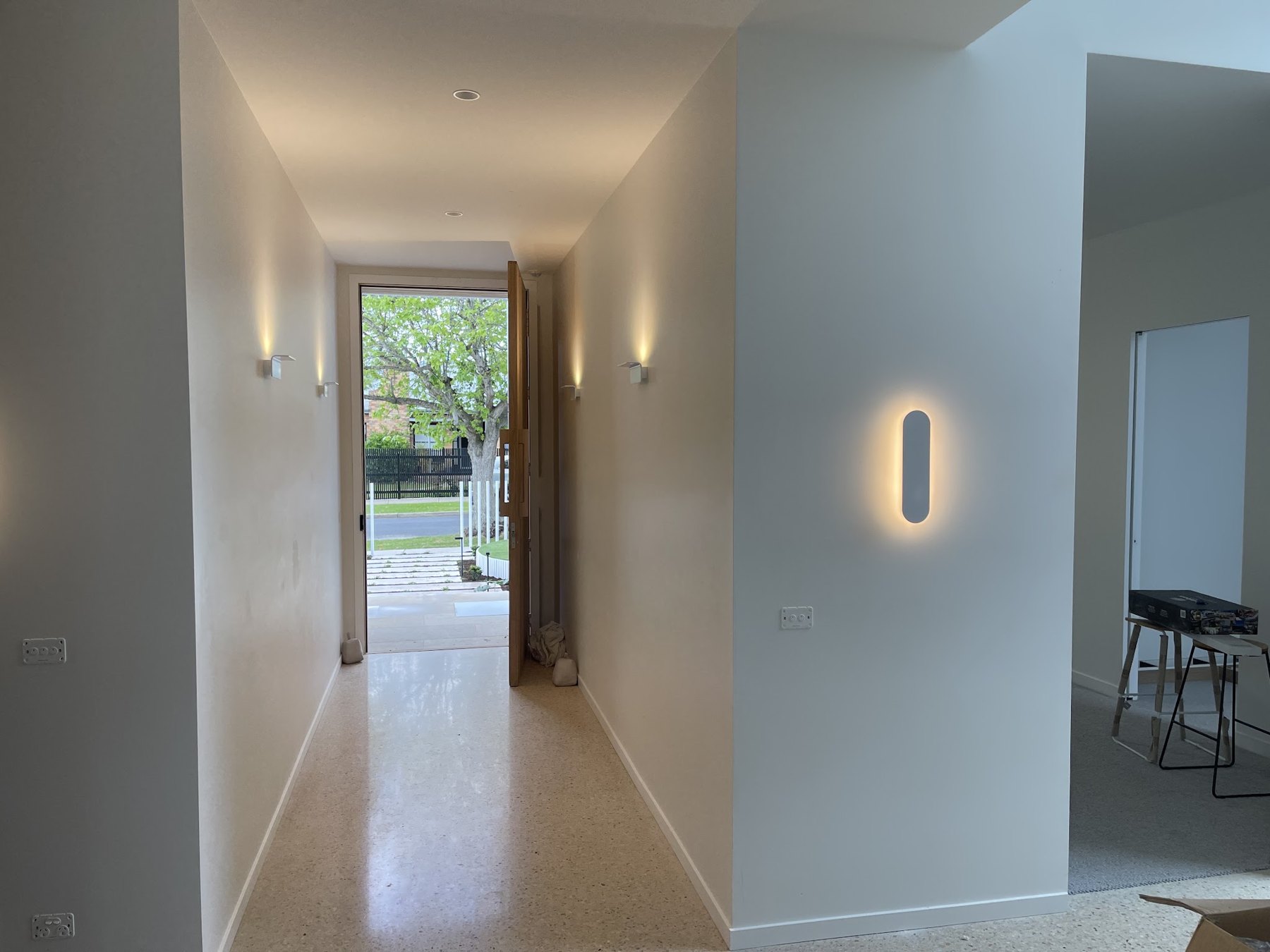 Hallway with up and down wall lights and an oval feature wall light