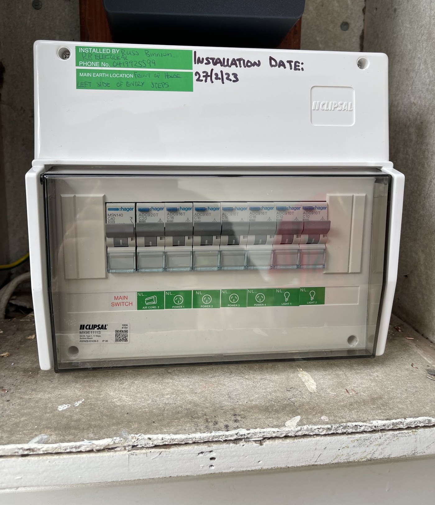 New Clipsal switchboard with a green label reading Installed by Russ Binnion, RB Electrical, and a handwritten installation date